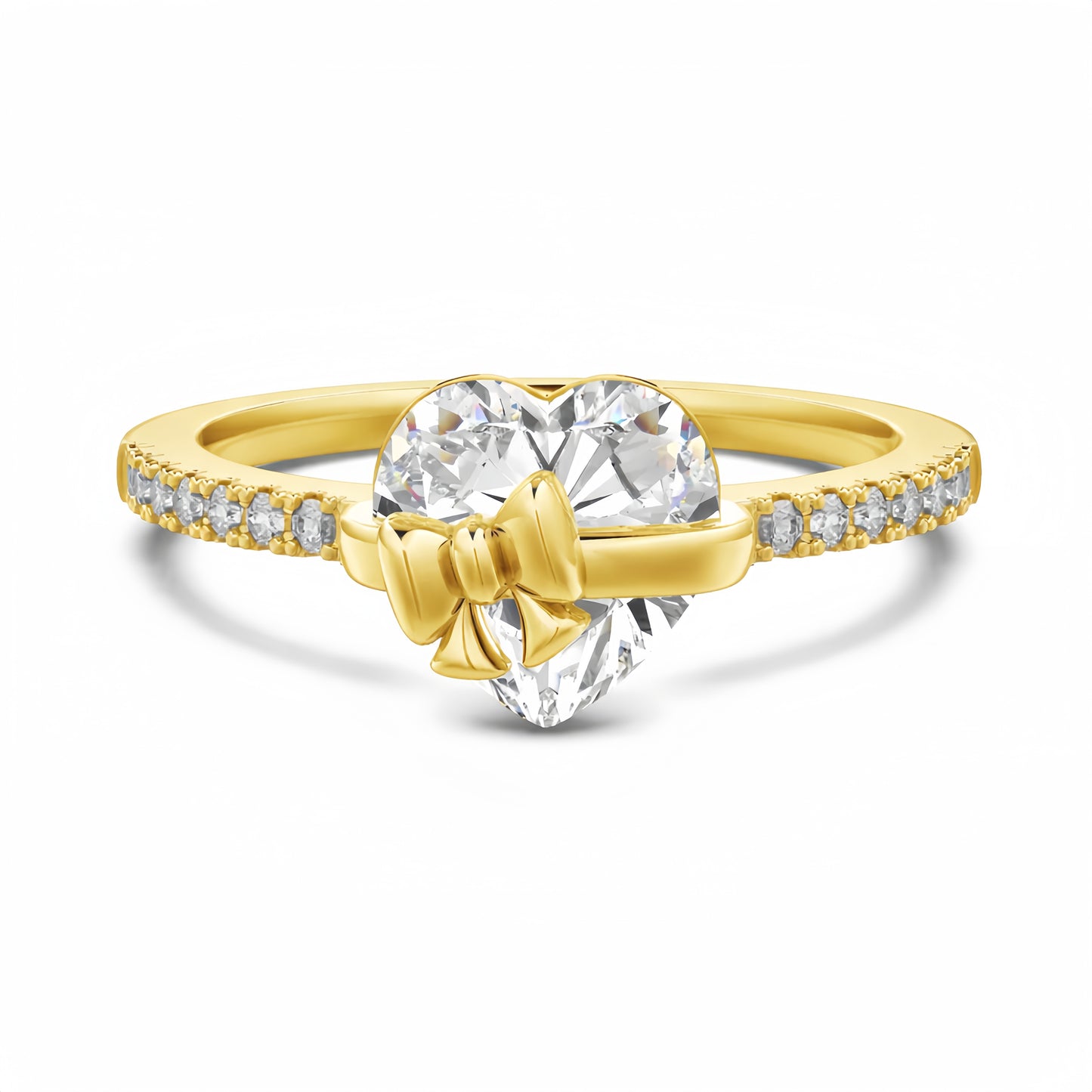 Gold ring with heart-shaped diamond and bow design on a white background